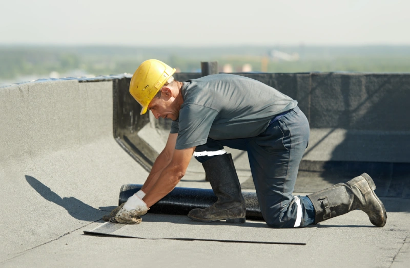 A man working on the roof of a building.